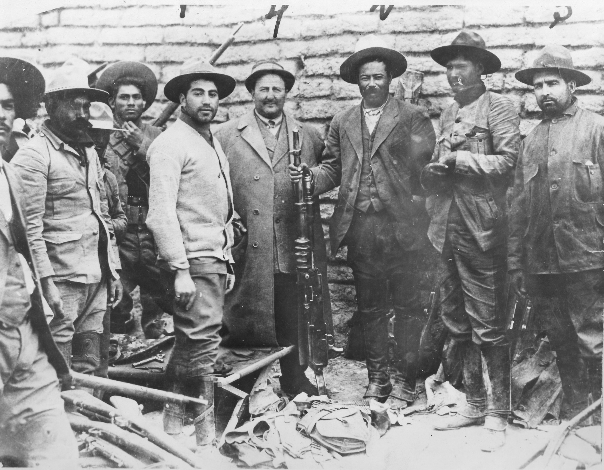 My grandfather, 5th from left in cardigan, with Pancho Villa, 3rd from right holding a machine gun.